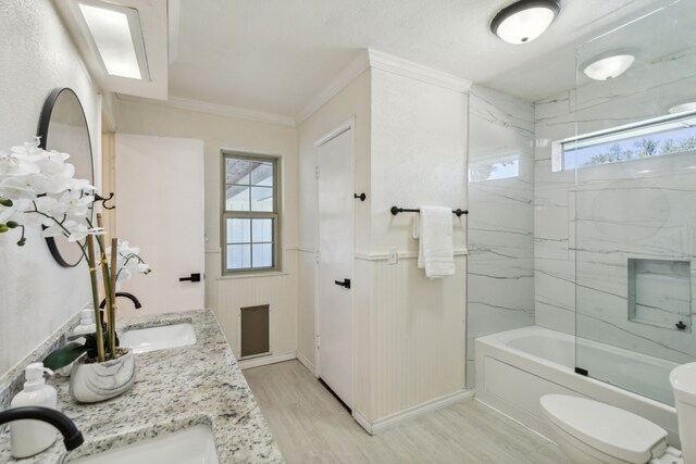 full bathroom with wood-type flooring, toilet, tiled shower / bath, and vanity