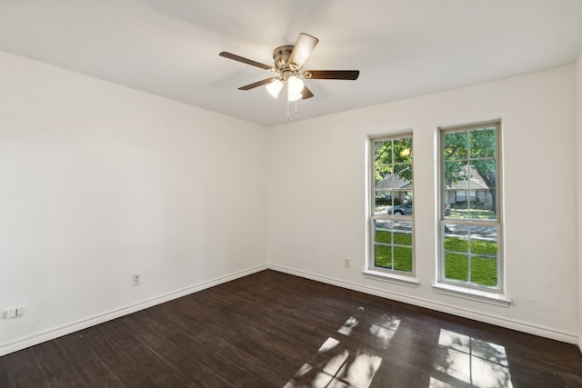 spare room featuring ceiling fan and dark hardwood / wood-style floors