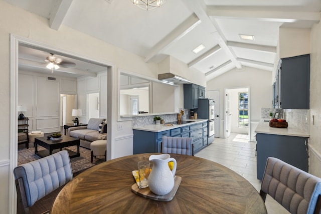 dining room with ceiling fan and vaulted ceiling with beams