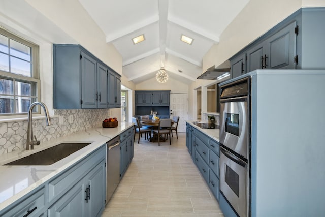 kitchen with a wealth of natural light, appliances with stainless steel finishes, decorative backsplash, sink, and lofted ceiling with beams