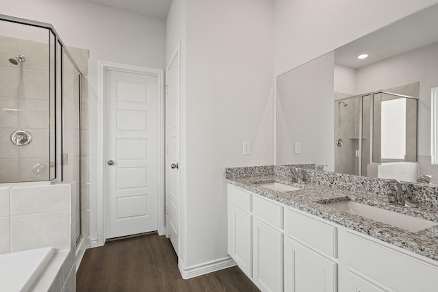 2412 Dahlia Dr, Fort Worth, TX 76123 - full bath featuring a stall shower, double vanity, wood finished floors, recessed lighting, and baseboards