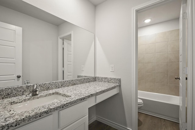 2412 Dahlia Dr, Fort Worth, TX 76123 - full bath featuring wood finished floors, vanity, toilet, and shower / washtub combination