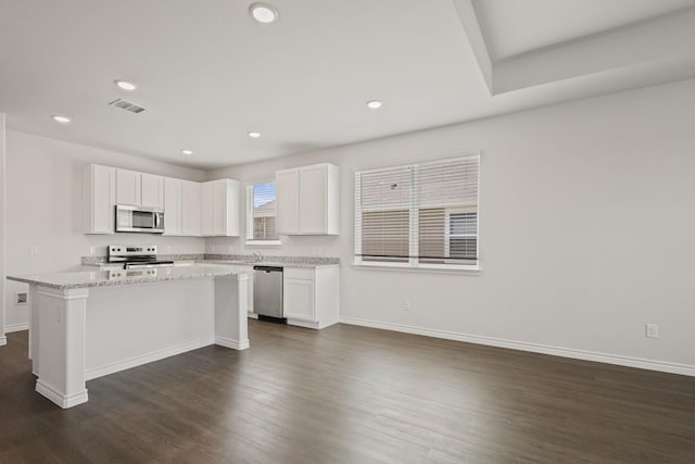 2412 Dahlia Dr, Fort Worth, TX 76123 - kitchen featuring appliances with stainless steel finishes, white cabinetry, dark wood-type flooring, baseboards, and recessed lighting