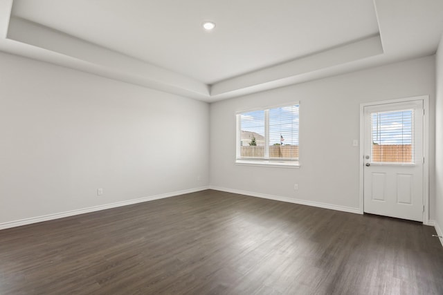 2412 Dahlia Dr, Fort Worth, TX 76123 - unfurnished room with dark wood finished floors, a tray ceiling, baseboards, and recessed lighting