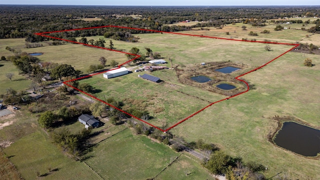 birds eye view of property featuring a rural view and a water view