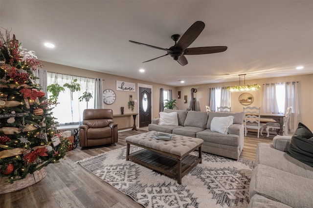 living room with ceiling fan and light hardwood / wood-style flooring