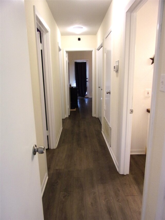 corridor with dark wood-type flooring