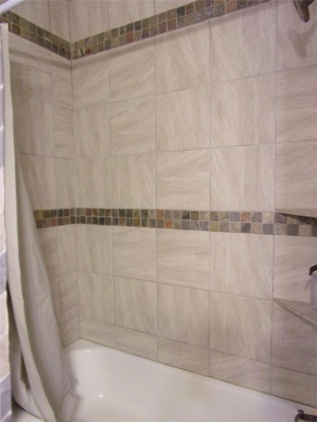 bathroom featuring shower / bathtub combination with curtain