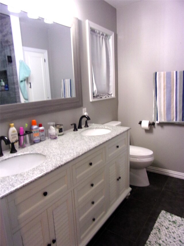 bathroom featuring tile patterned floors, vanity, and toilet