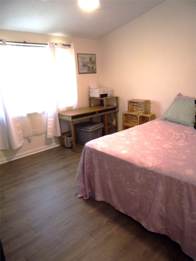 bedroom with dark wood-type flooring