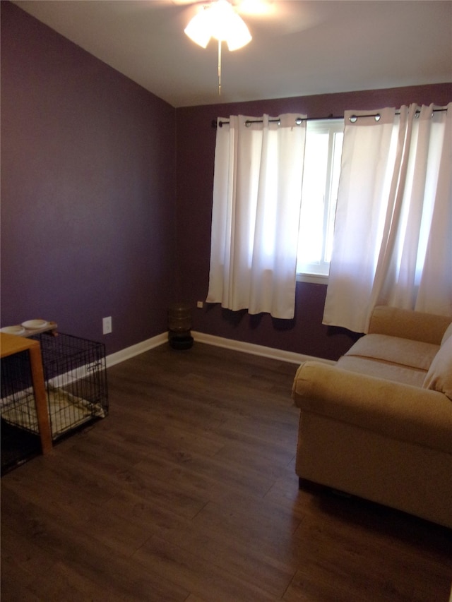 sitting room featuring ceiling fan and dark wood-type flooring