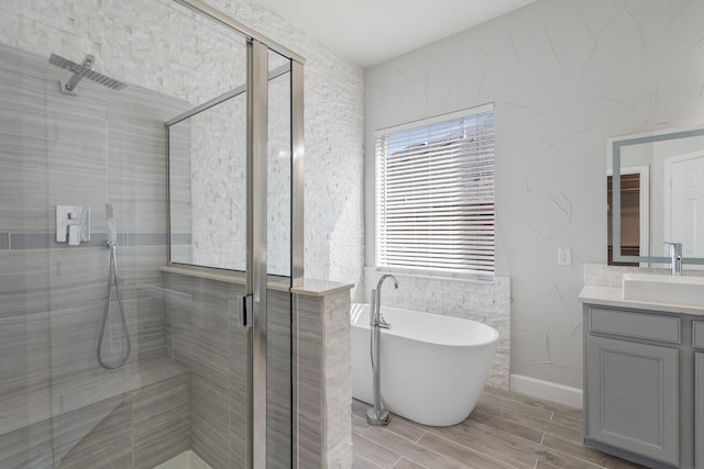 bathroom featuring vanity and shower with separate bathtub