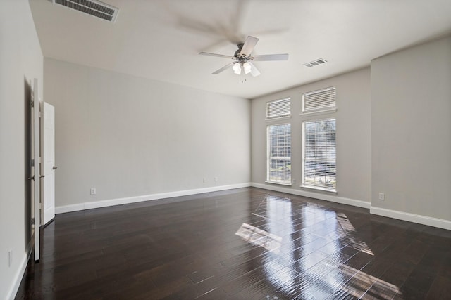 empty room with ceiling fan and dark wood-type flooring