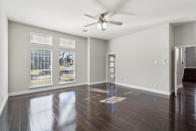 spare room featuring ceiling fan and dark hardwood / wood-style floors