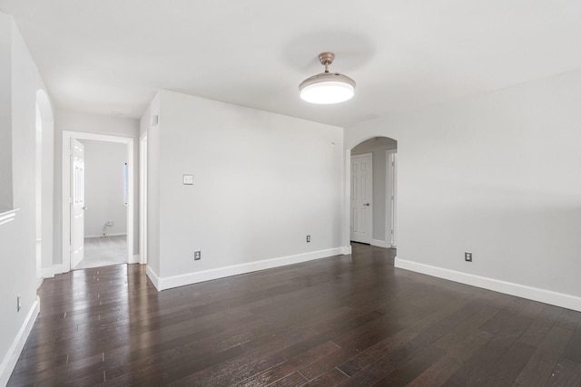 empty room with dark hardwood / wood-style floors