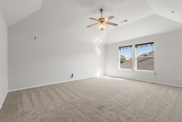 empty room featuring carpet flooring, vaulted ceiling, and ceiling fan