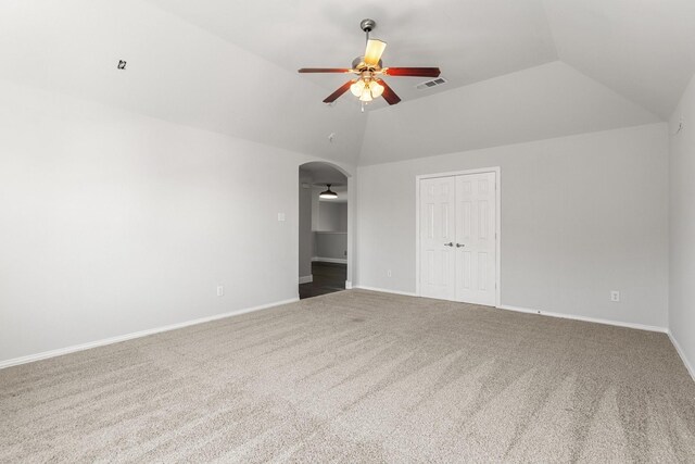 spare room featuring carpet flooring, ceiling fan, and lofted ceiling