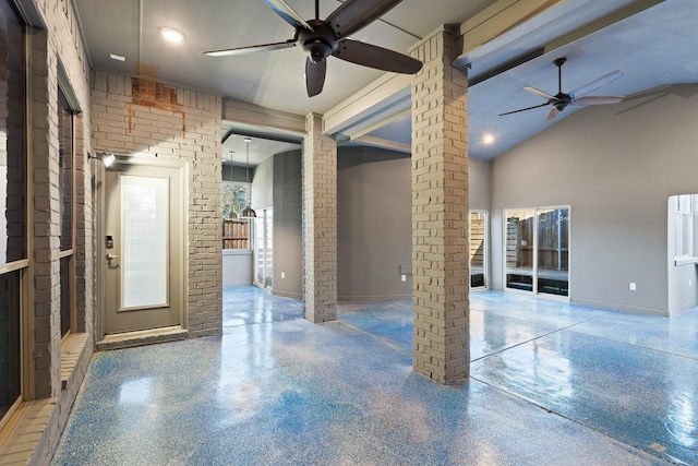 unfurnished room with high vaulted ceiling, ornate columns, ceiling fan, and brick wall