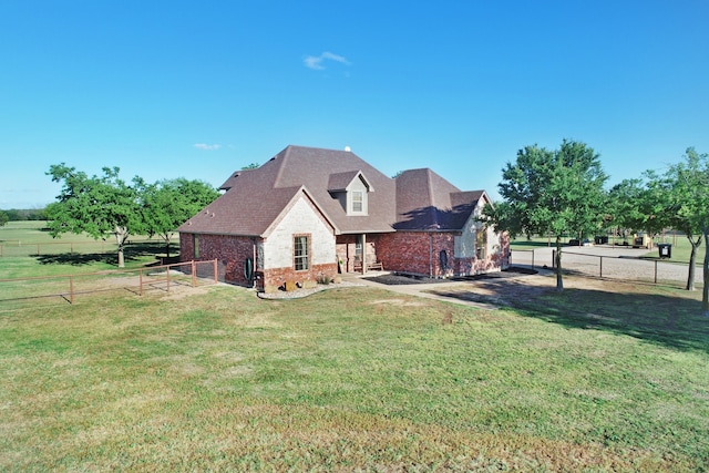 back of property featuring a yard