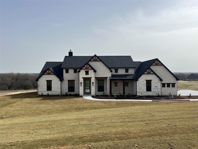 view of front of property featuring a front yard and a chimney