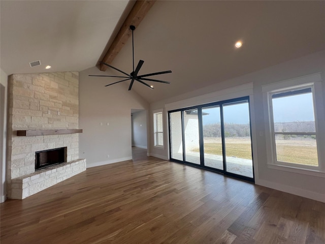 unfurnished living room featuring beamed ceiling, a fireplace, wood finished floors, and visible vents