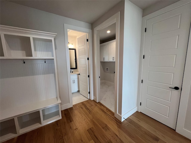 mudroom featuring dark wood-style floors and baseboards