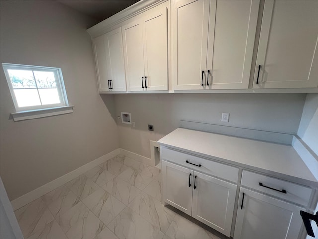 washroom with marble finish floor, hookup for a washing machine, cabinet space, hookup for an electric dryer, and baseboards