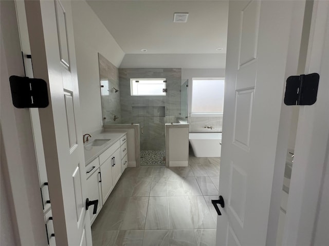 full bath featuring visible vents, marble finish floor, walk in shower, vanity, and a freestanding tub