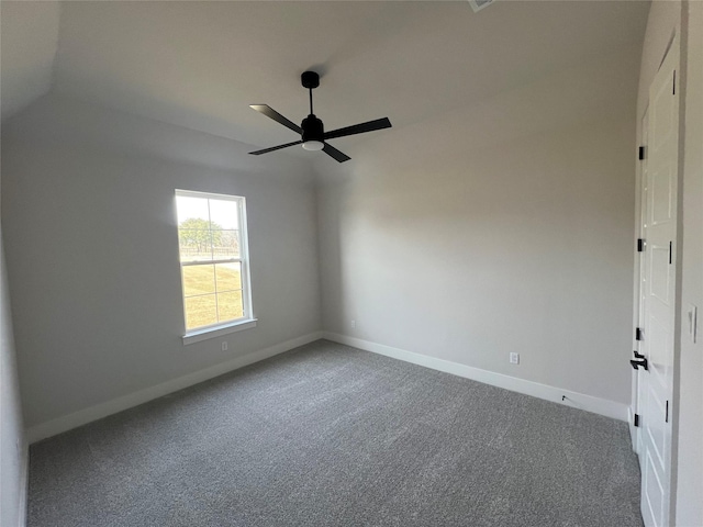 empty room with ceiling fan, carpet flooring, and baseboards