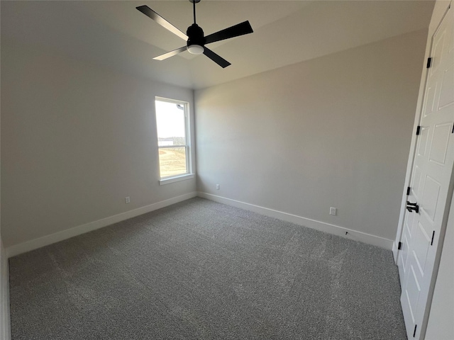 carpeted empty room with ceiling fan and baseboards