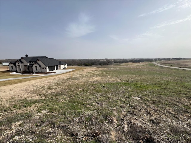 view of yard with a rural view