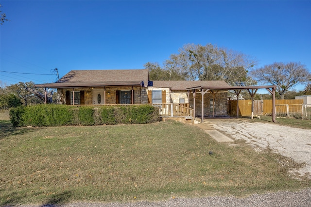 single story home featuring a front yard and a carport