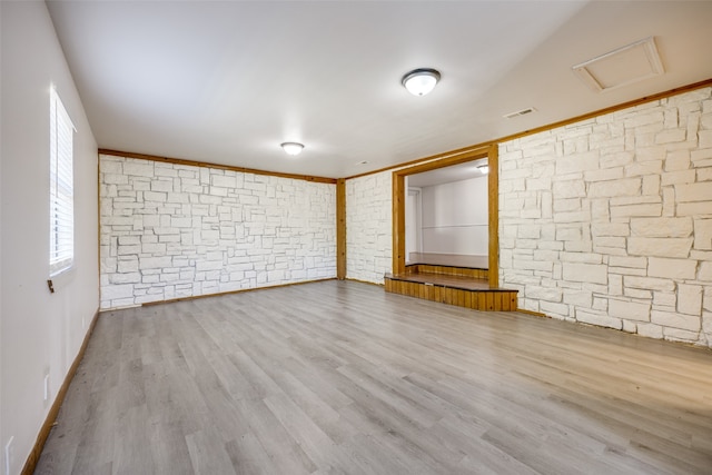 empty room featuring light hardwood / wood-style floors and crown molding