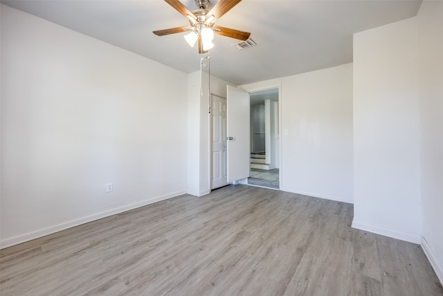 spare room with ceiling fan and light hardwood / wood-style floors