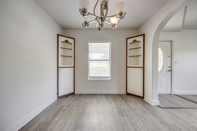 foyer with a chandelier and light wood-type flooring