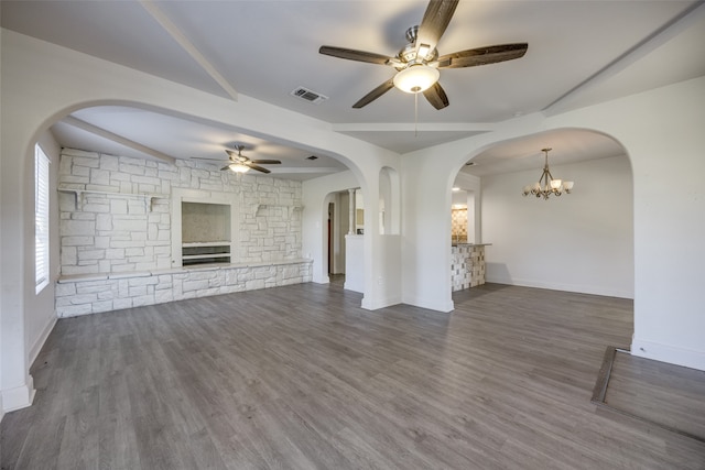 unfurnished living room with beamed ceiling, ceiling fan with notable chandelier, dark hardwood / wood-style flooring, and a fireplace