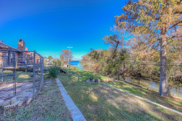 view of yard featuring a deck with water view