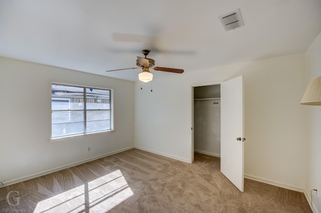 unfurnished bedroom with ceiling fan, a closet, and light carpet