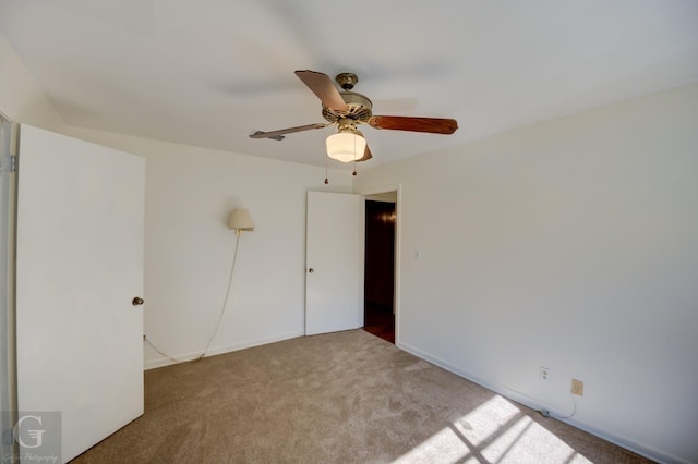 unfurnished bedroom with ceiling fan and light colored carpet