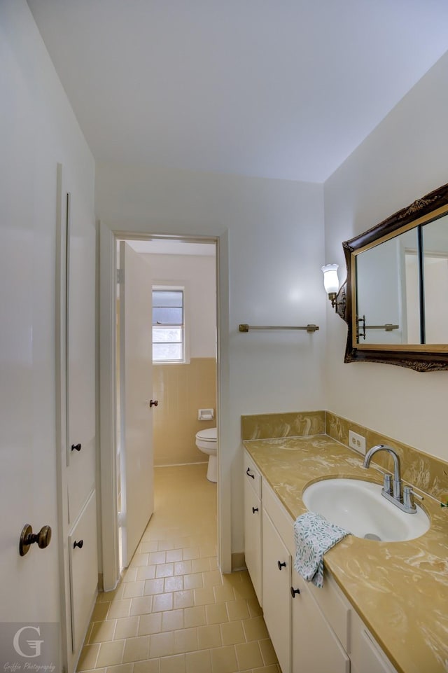 bathroom with tile patterned floors, vanity, and toilet