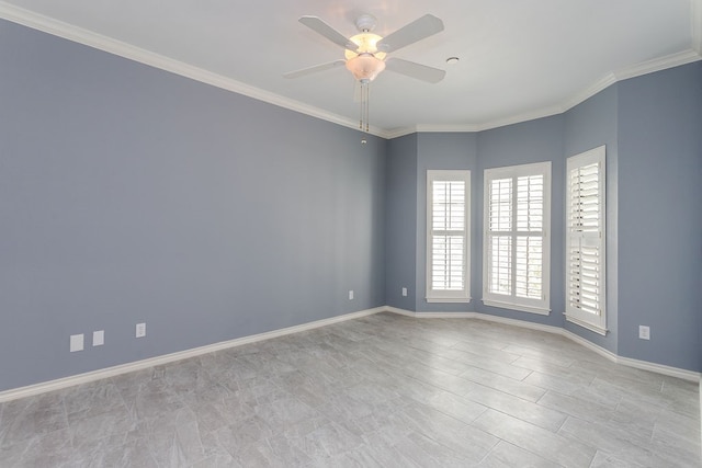 empty room featuring ceiling fan and crown molding