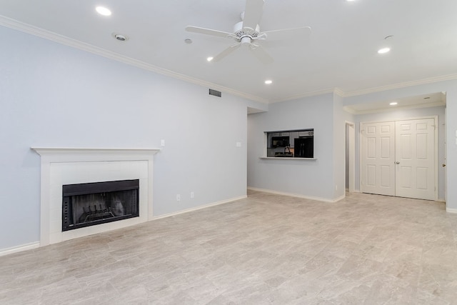 unfurnished living room featuring ceiling fan, ornamental molding, and a tiled fireplace