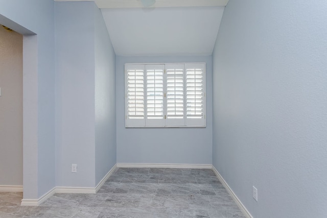 empty room with vaulted ceiling