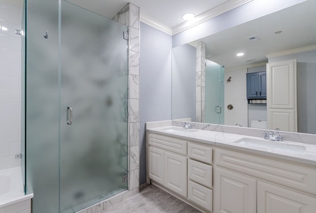 bathroom featuring vanity, a shower with door, and crown molding