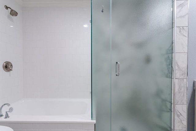 bathroom featuring shower with separate bathtub