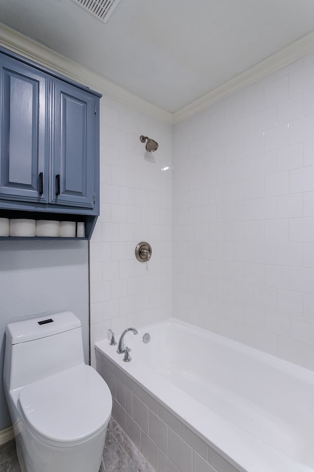 bathroom with tile patterned floors, tiled shower / bath combo, toilet, and ornamental molding