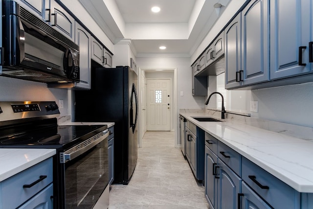 kitchen with light stone countertops, sink, stainless steel appliances, blue cabinets, and ornamental molding