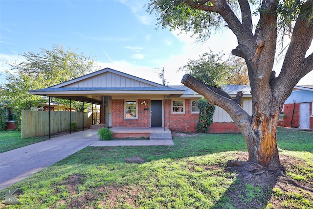 single story home featuring a carport, a porch, and a front yard