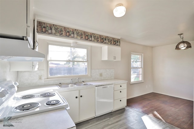 kitchen featuring dark hardwood / wood-style flooring, white appliances, white cabinetry, and sink