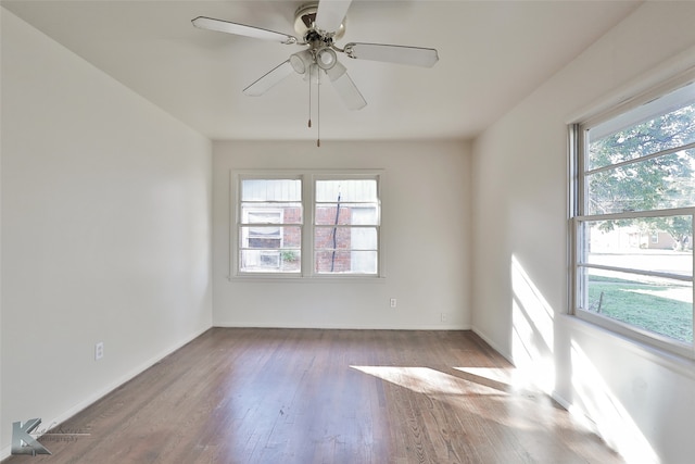 spare room featuring ceiling fan, plenty of natural light, and hardwood / wood-style flooring